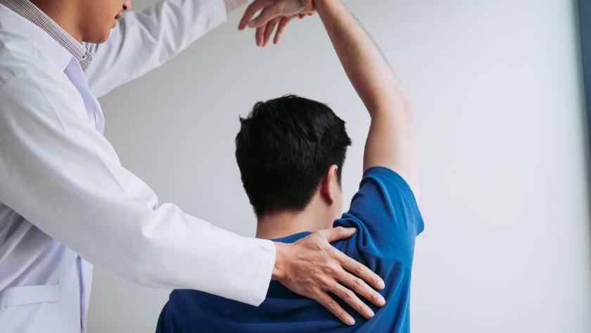 chiropractor-stretching-a-young-man-arm