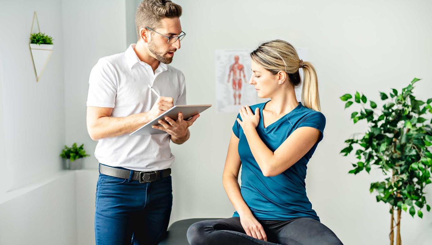chiropractor having discussion with patient