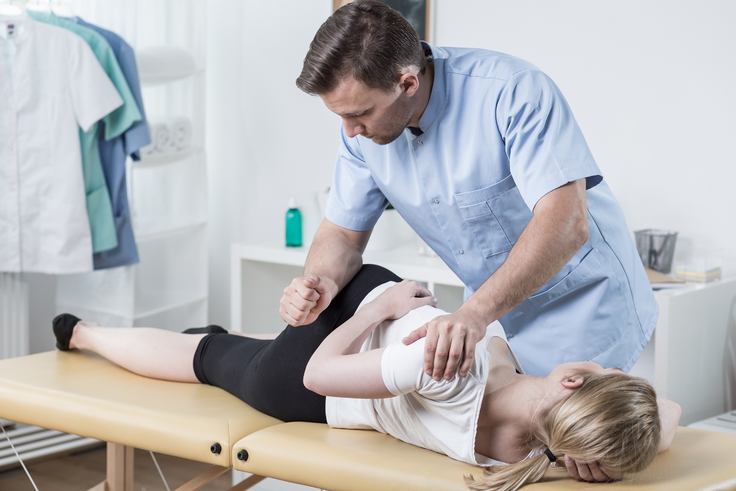 chiropractor massaging a girl